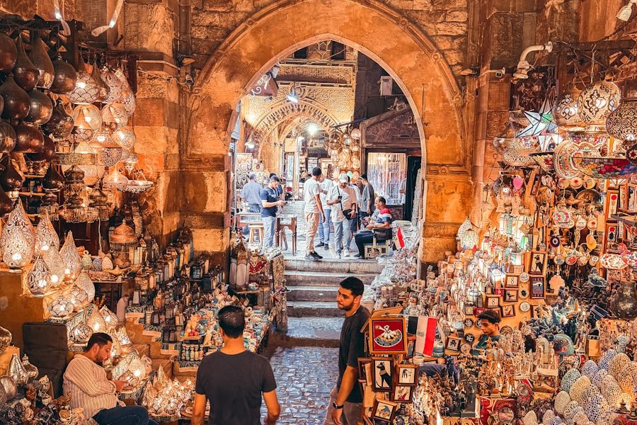 Two men walking through a market filled with lots of items