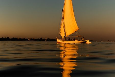 a sailboat sailing on a body of water