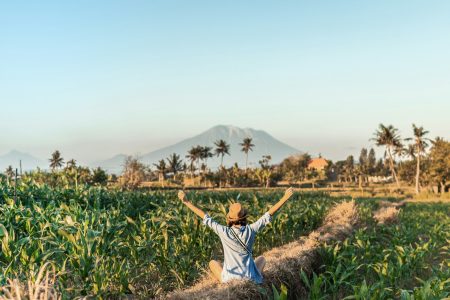 woman on pathway surrounded by plants