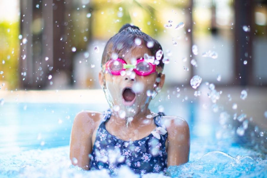 girl swims on swimming pool